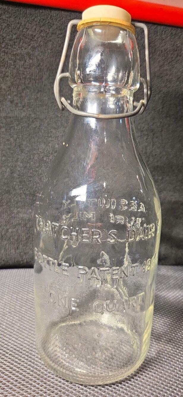 Thatcher's Dairy one-quart glass milk bottle embossed cow wire bail-top closure